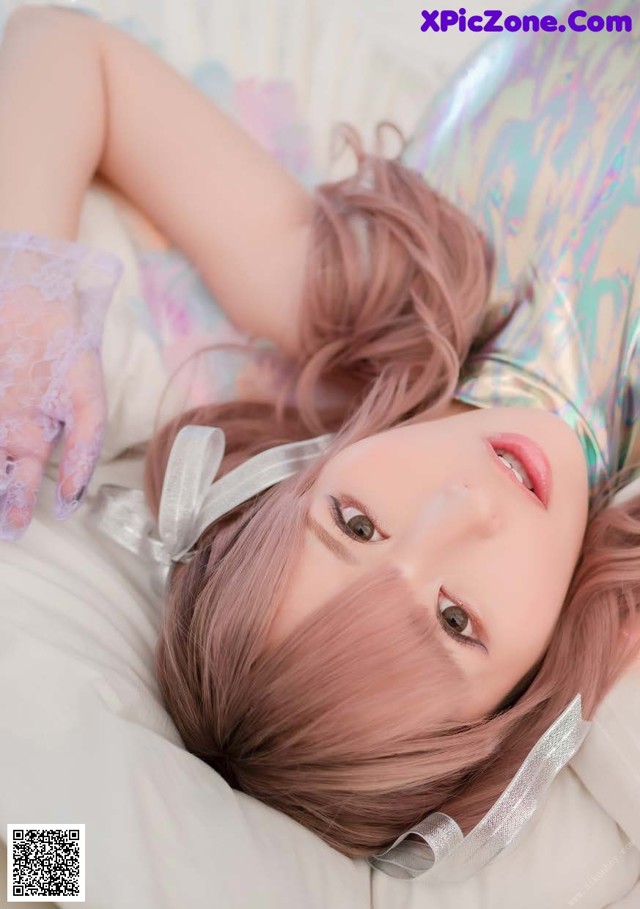A woman laying on top of a bed wearing a mermaid costume.