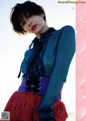 A magazine with a picture of a woman in a blue dress.