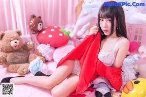 A woman in a red and white outfit is posing for a picture.