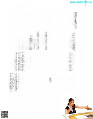 A woman in a black jacket and white shirt posing for a magazine.