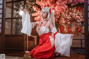 A woman in a red and white outfit posing for a picture.