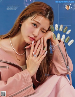 A woman in a white sweater is posing for a magazine.