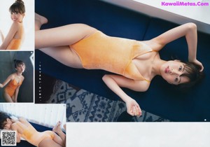 A woman in a blue bikini sitting on a bed.