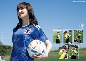 A young woman holding a soccer ball on a field.