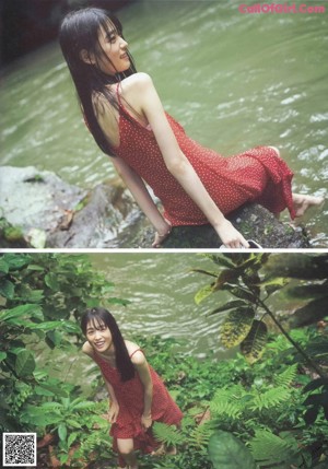 A woman in a red polka dot dress laying on a wooden table.