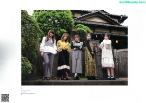 A woman in a white sweater is posing for a magazine.