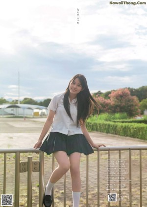 A woman in a blue and white dress posing for a picture.