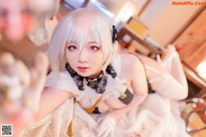 A woman dressed in a maid outfit posing for a picture.