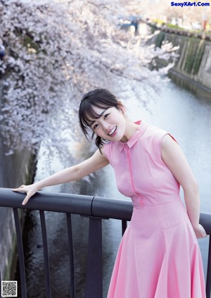 A woman in a white dress posing for a picture.