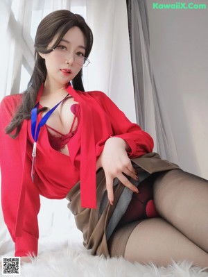 a woman in a red shirt and black stockings sitting on a chair