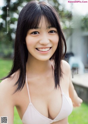 A young woman in a school uniform posing for a picture.
