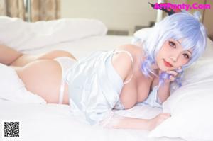 A woman with blue hair wearing a white bra and panties.