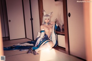 A woman in white stockings is sitting on a tatami mat.