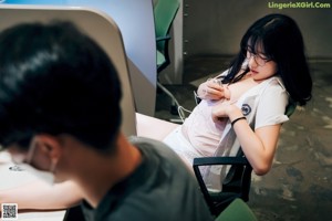 A woman sitting in a chair with a stethoscope around her neck.